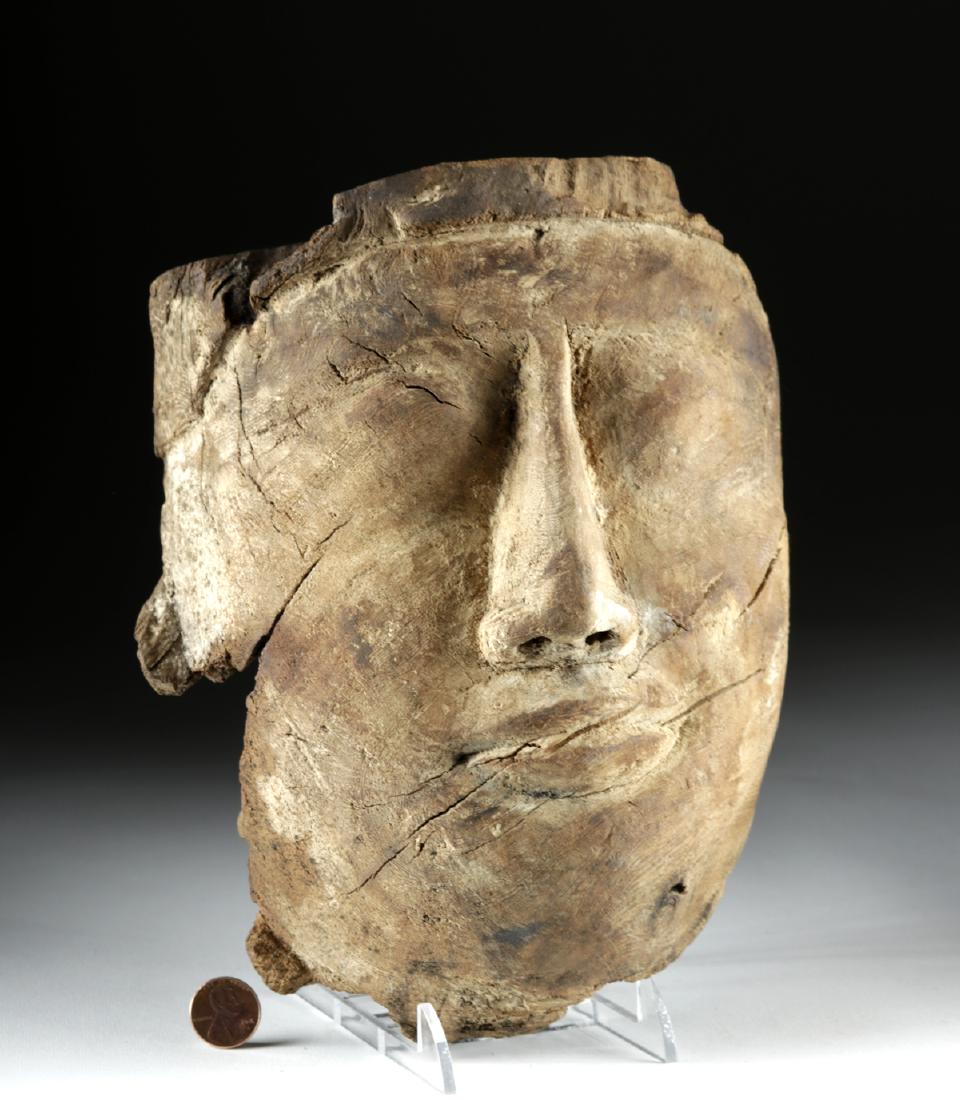 Egyptian Wood Mummy Mask: Ancient Egypt, Third Intermediate Period, Dynasties 21 to 25, ca. 1070 to 712 BCE. A hand-carved wooden mummy mask that likely once had copper and stone eyes attached to it and would have been covered