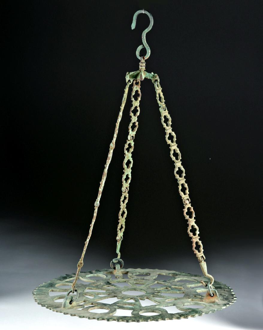 Byzantine Bronze Hanging Candelabrum: Near East/Holy Land, Byzantine Empire, ca. 6th to 9th century CE. A beautiful, fascinating object from a wealthy Byzantine home or church - a round, spoke-like component of a candelabrum. A symmetrica