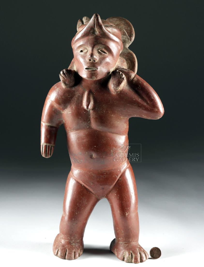 Fine Colima Pottery Standing Shaman: Pre-Columbian, West Mexico, Colima, ca. 100 BCE to 250 CE. A superb redware standing male figure with an animated pose - his body leaning slightly forward, his legs spread apart with large feet plante