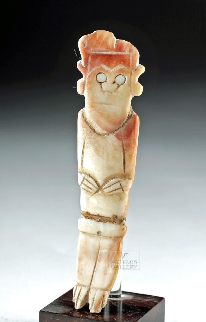 Colima Carved Shell Standing Figure / Purging Stick: Pre-Columbian, West Mexico, Colima, ca. 300 BCE to 300 CE. Hand-carved from clam shell, a male figure - perhaps intended as a purging stick - delineated with circular abalone shell eyes, incised arche