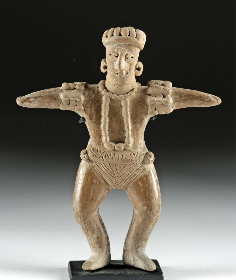 Colima Pottery Standing Ball Player: Pre-Columbian, West Mexico, Colima, ca. 300 BCE to 300 CE. A wonderful example of a hand-built pottery figure depicting a male ball player standing atop bent legs. He wears a striated loincloth and an