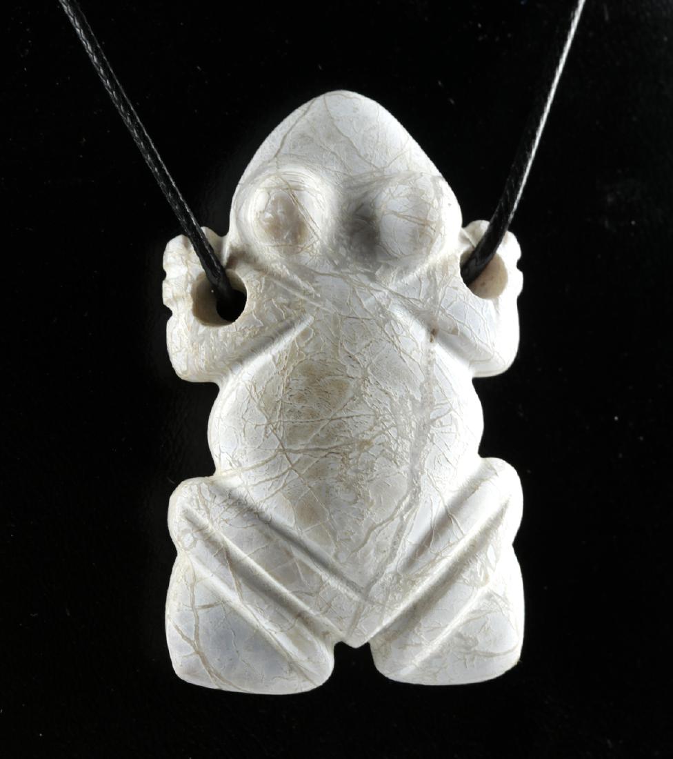 Costa Rican Stone Frog Amulet w/ Original Caliche: Pre-Columbian, Central America, Costa Rica, Guanacaste / Nicoya region, ca. 200 to 600 CE. A hand-carved stone amulet depicting a stylized frog with retracted legs, a bulbous body, and a triangular he