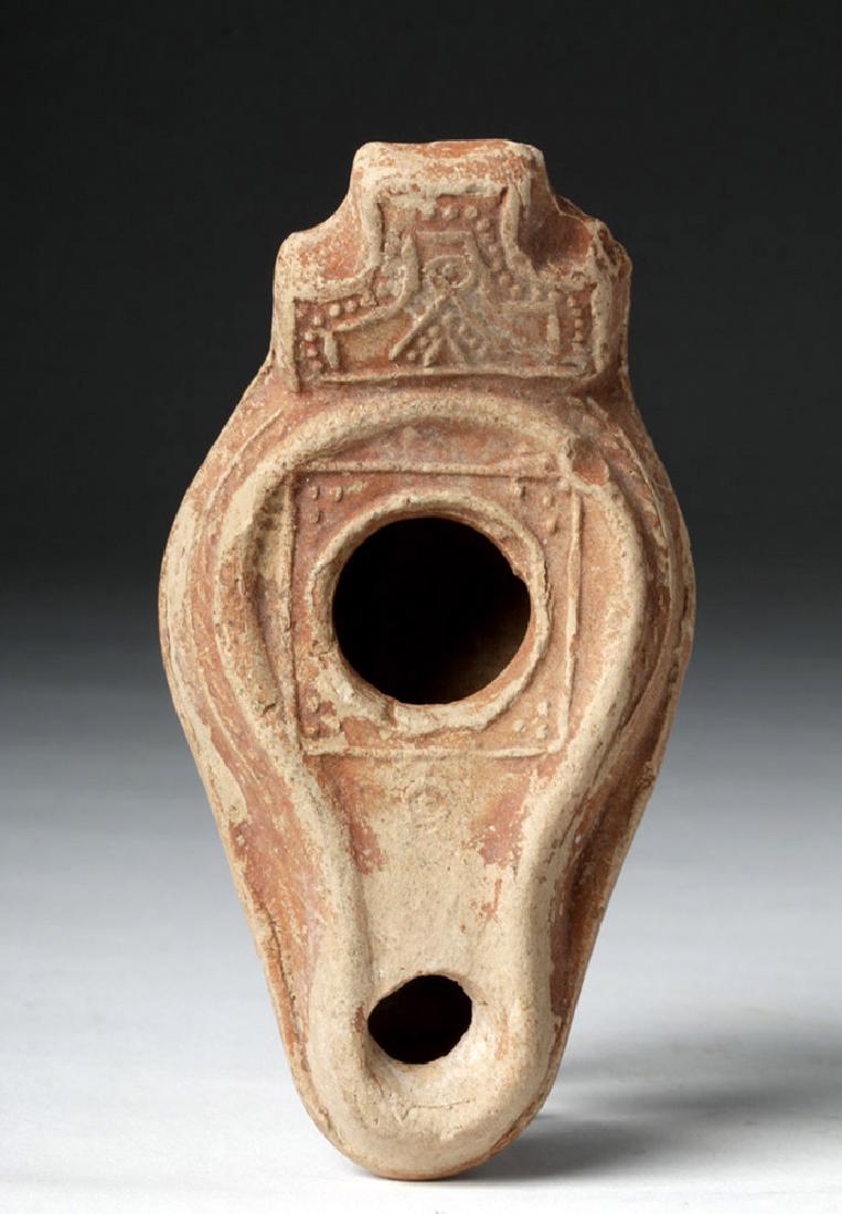 Byzantine Terracotta Oil Lamp: **Originally Listed At $100** Ancient Mediterranean, Late Roman / Byzantine, ca. 7th to 8th Century CE. A mold-made, heavy ceramic oil lamp with a flat, angled handle in the Byzantine style. An abstra