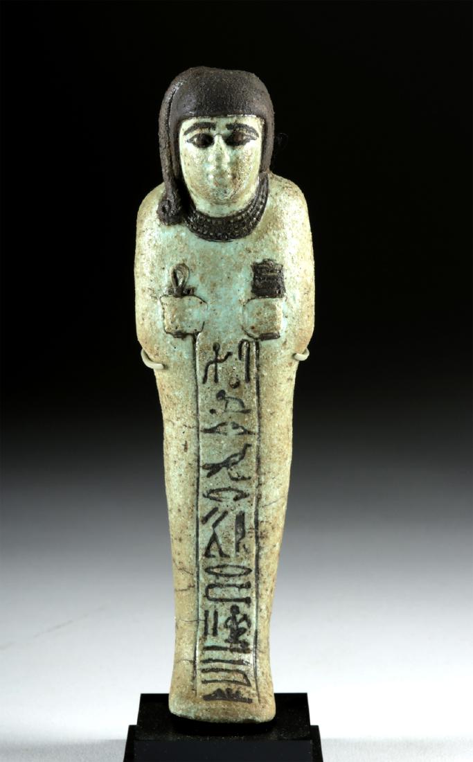 Egyptian New Kingdom Faience Ushabti for Hori: Ancient Egypt, New Kingdom, Ramesside Period, 19th to 20th Dynasty, ca. 1295 to 1070 BCE. A mold-formed faience ushabti covered in a pale blue-green glaze and accentuated with black-painted details. T