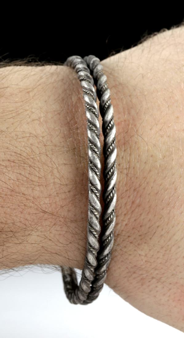 Viking Silver Twisted Double Wire Bracelet, 49.4 g: Northern Europe, Viking or Norse culture, ca. 8th to 11th century CE. A beautiful double-stranded bracelet composed of twisted high-grade (98-99%) silver wire. The bracelet wires were first twisted an