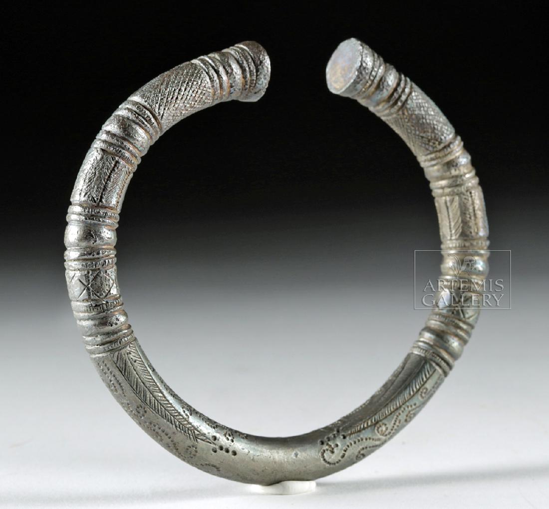 Large Achaemenid Silver Bracelet, 194.5 g: Ancient Near East, Achaemenid Persian Empire, ca. 500 to 330 BCE. A fabulous bracelet of a substantial size and weight, formed from a singular curved rod of high-grade (98%) silver. The bangle exhibit