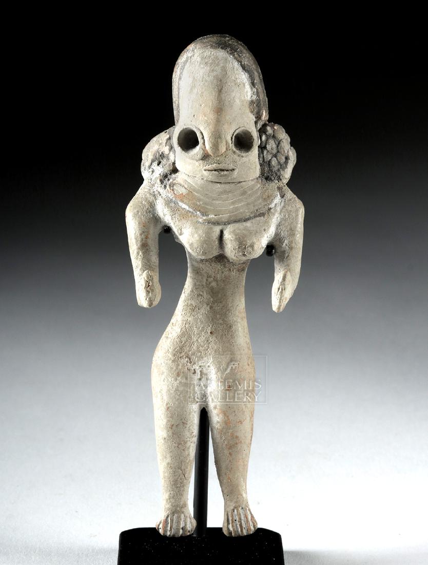 Indus Valley Mehrgarh Pottery Fertility Figure: Ancient Central Asia, Indus Valley, Mehrgarh period, ca. 3500 to 2800 BCE. A characteristically-abstract Indus Valley female figure, positioned in a seated pose, with her hands extended outward. She b