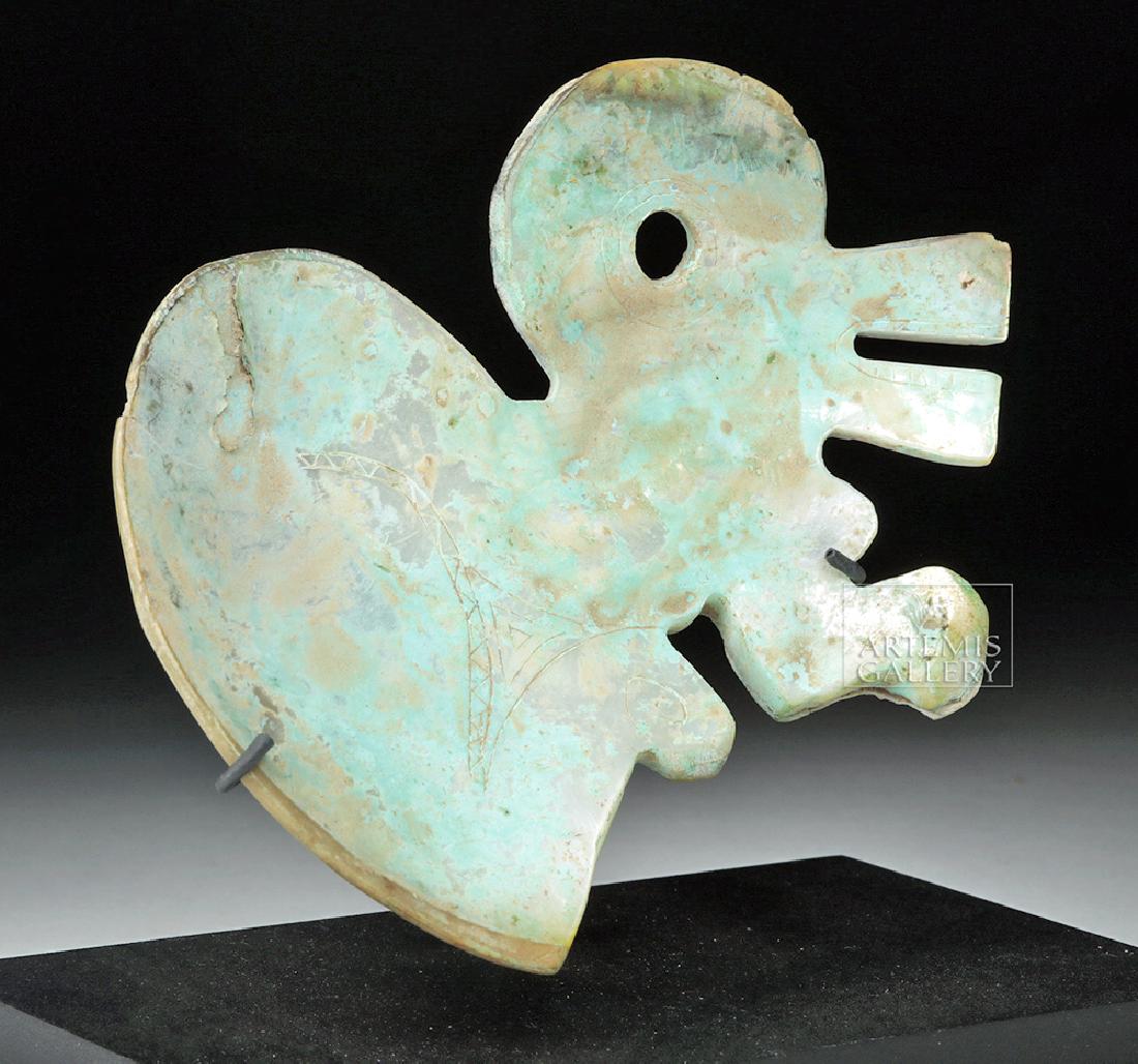 Rare Colombian Tairona Shell Pectoral - Bird Form: Pre-Columbian, South America, Colombia, Tairona, ca. 1000 CE. A breathtaking shell ornament created by the Tairona peoples, an ancient and now extinct culture of Colombia, depicting a bird in a charac