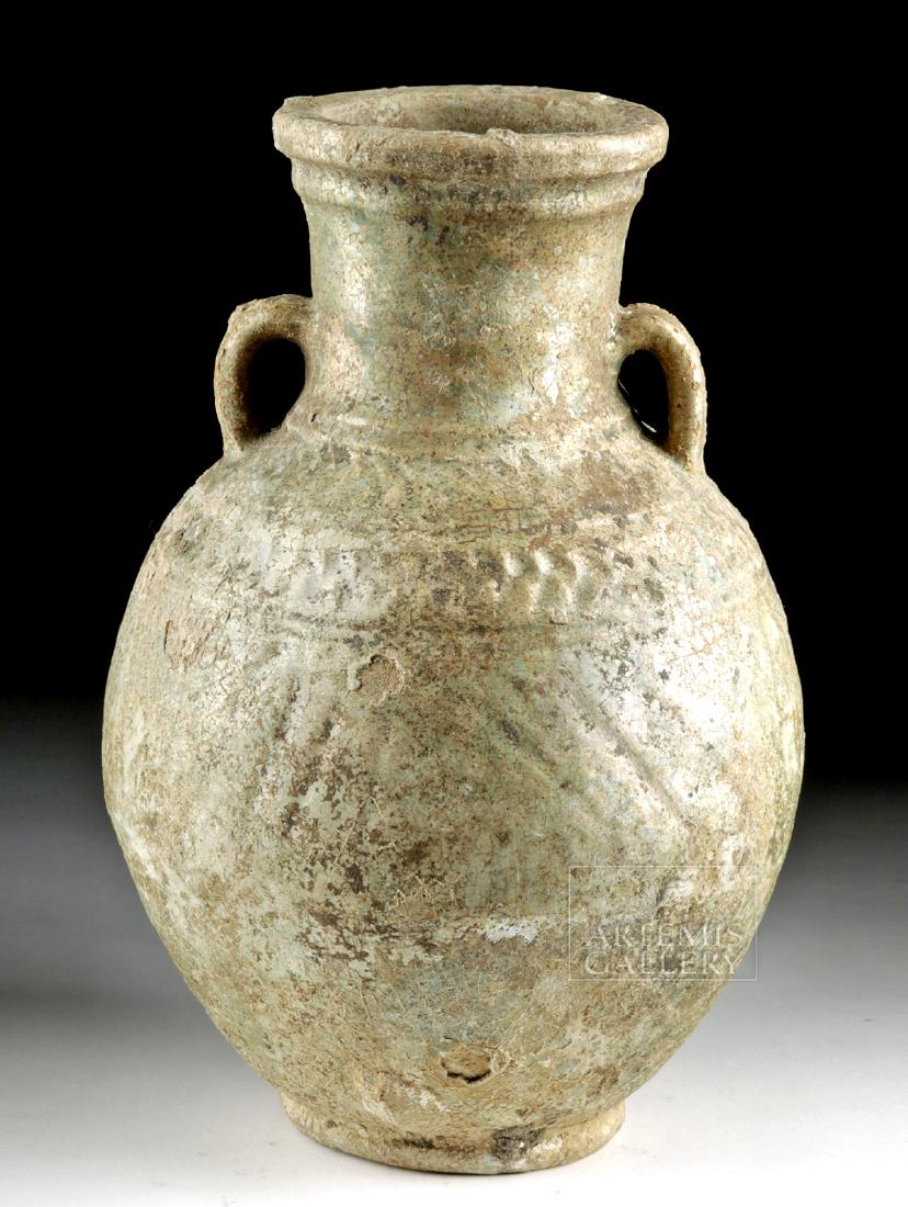 Umayyad / Early Abbasid Turquoise Glazed Ceramic Jar: Ancient Near East, western Iran or Iraq, Umayyad Caliphate or early Abbasid, ca. 8th to 9th century CE.A gorgeous earthenware jar with an amphora-like shape - a rounded, elongated body, a disc foot, a