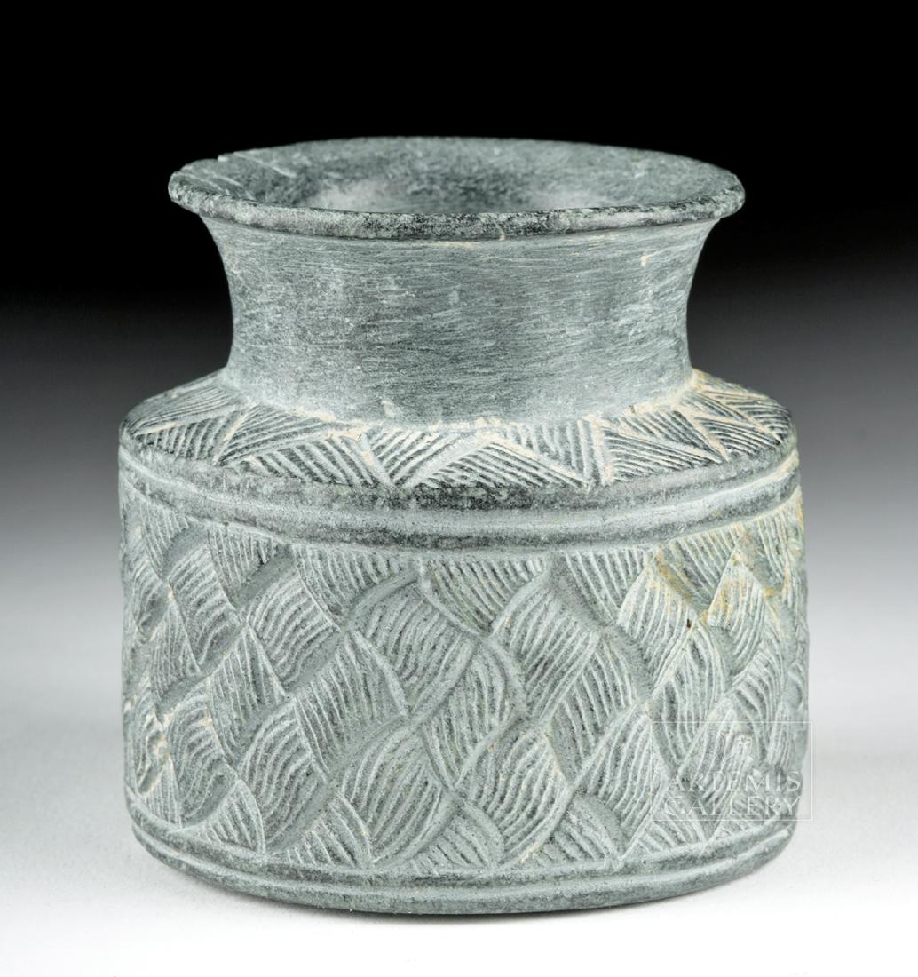 Bactrian Chlorite Schist Jar w/ Incised Motifs: Ancient Central Asia, Bactrian, ca. 2500 to 2250 BCE. A beautiful jar of a squat form with a flat base, a cylindrical body, and a tubular neck with a flared rim, hand-carved from grey-blue chlorite sc