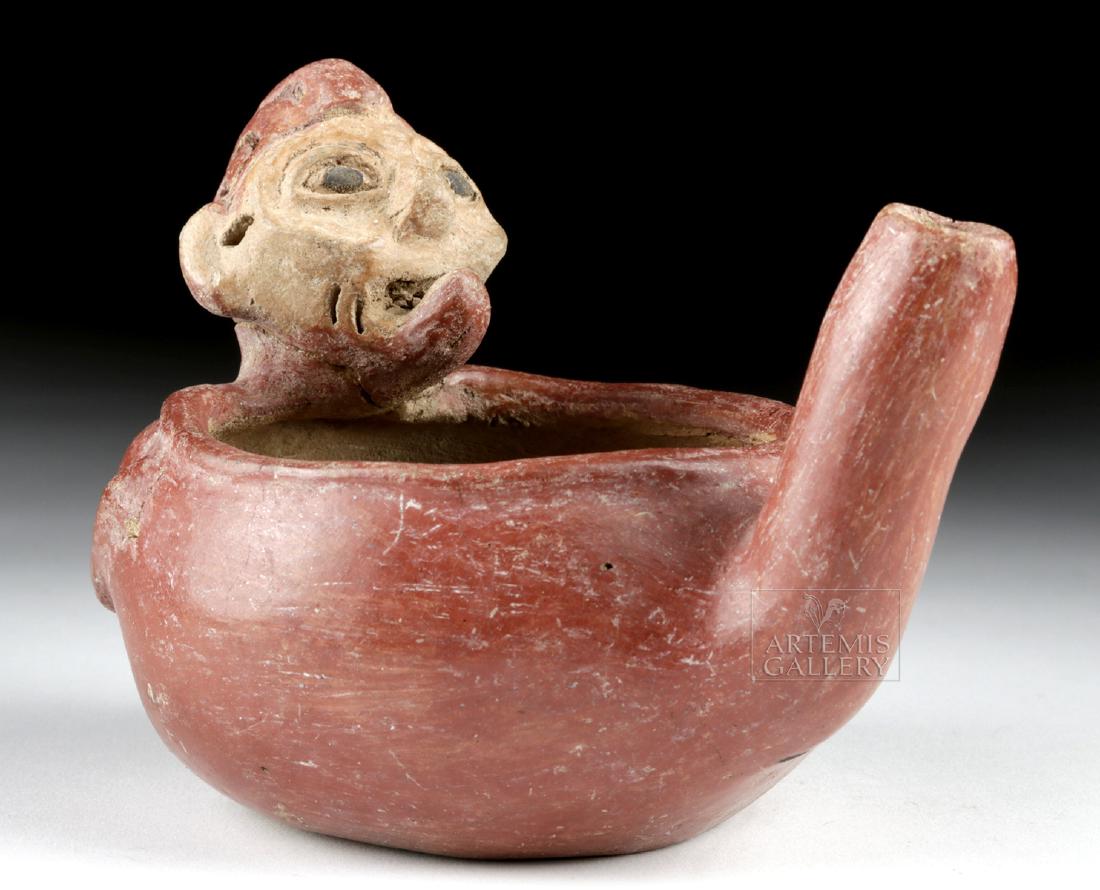 Rare Tlatilco Pottery Figural Spouted Drinking Vessel: Pre-Columbian, Mexico, Morelos, Tlatilco, ca. 500 to 100 BCE. A very unusual anthropomorphic redware vessel, its form comprised of a rounded cup with the head of an elderly man with bulging eyes (almo
