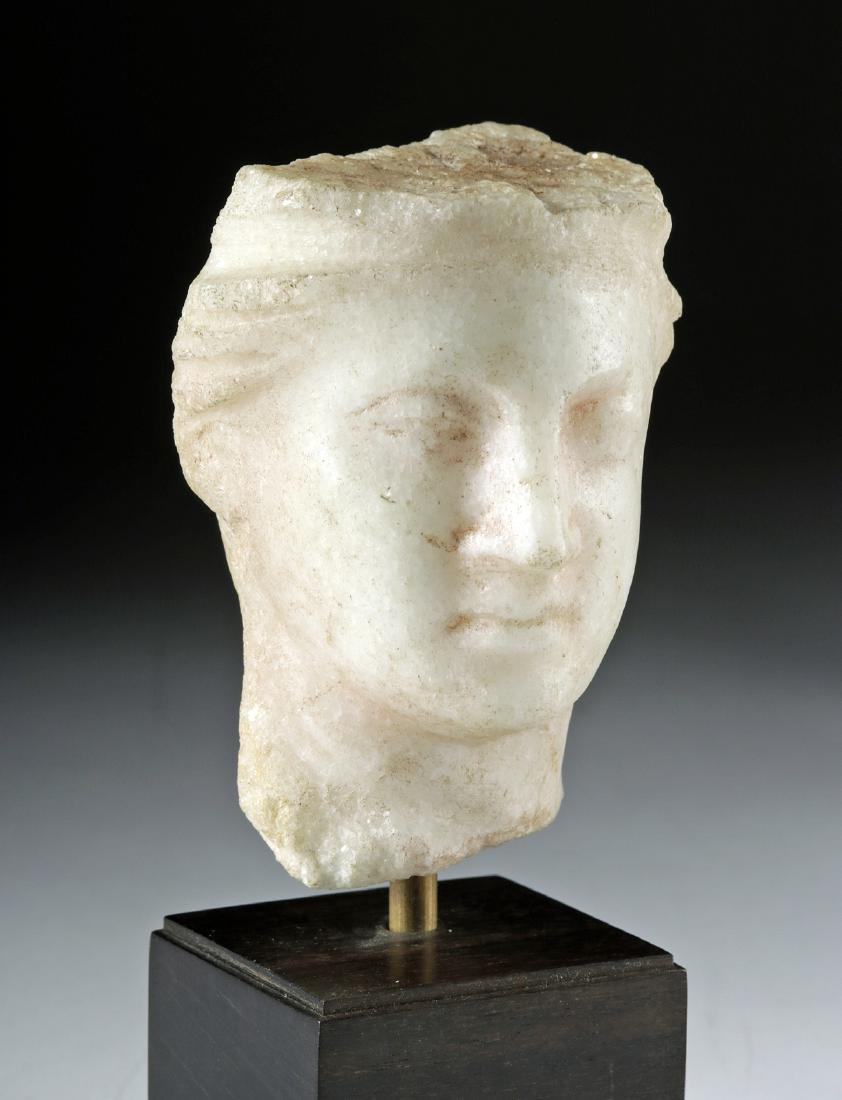 Roman Marble Head of a Goddess: Rome, Imperial Period, ca. 1st century CE. A skillfully carved, fine-crystalline white marble head depicting an ideal beauty of the classical world - probably Venus (Greek Aphrodite), the goddess of r