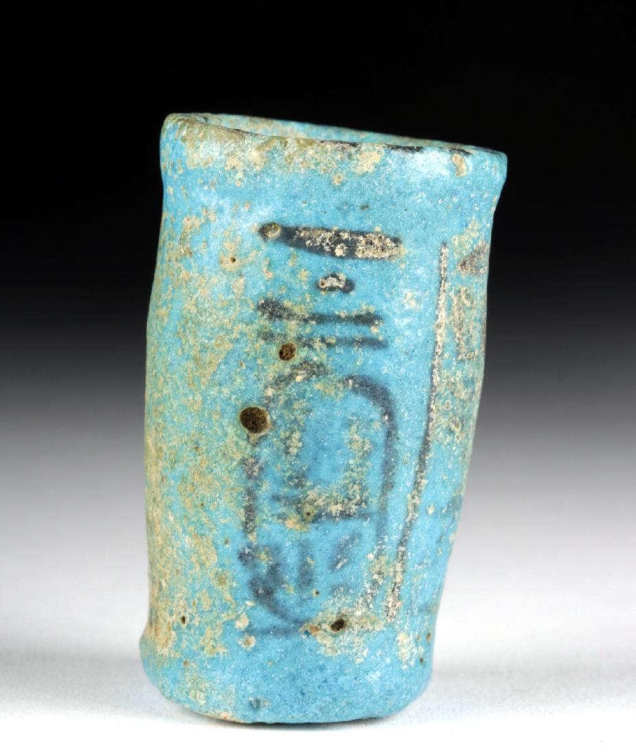 Egyptian Faience Cup w/ Royal Cartouche: Ancient Egypt, New Kingdom Period, 18th to 20th Dynasty, ca. 1549 to 1069 BCE. A petite faience offering cup with a planar base, a cylindrical body, and a rounded rim, all covered in lustrous turquois