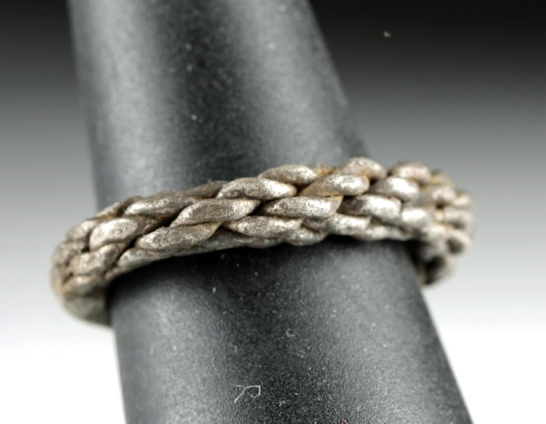 Wearable Viking Silver Ring - 6.7 g: Northern Europe, Viking/Norse culture, ca. 1000 CE. A ring made of twisted high quality (94%)silver wire which has been loosely braided, with the terminals pressed together to form flat ends. The piec