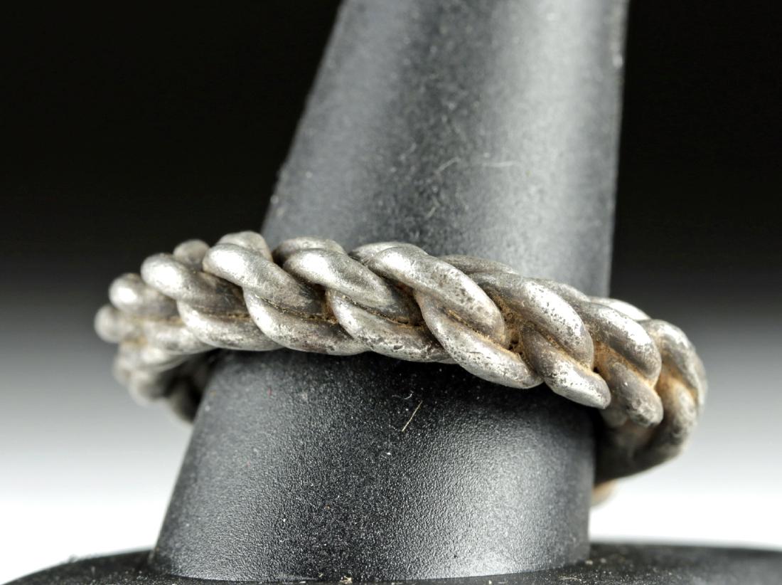 Large Viking Braided Silver Ring, 16.1 g: Northern Europe, Viking or Norse culture, ca. 800 to 1100 CE. A fabulous and wearable ring comprised of four braided strands of high-grade (94%) silver. The elegant circular design tapers to the fused