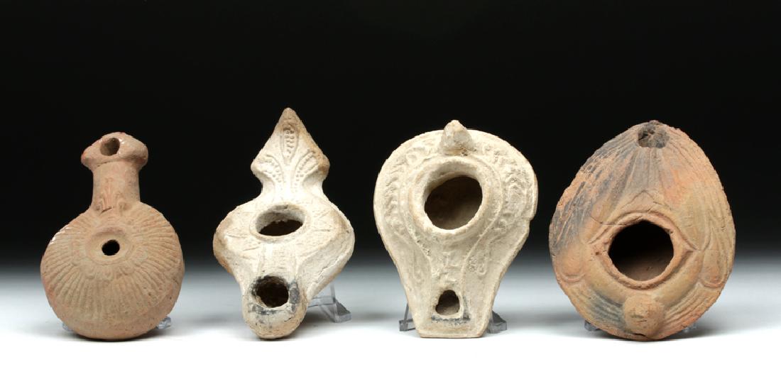 Lot of 4 Byzantine Terracotta Oil Lamps: **Originally Listed At $150** Late Roman Empire / Early Byzantine period, ca. 4th to 7th century CE. A wonderful selection of early Byzantine mold-made terracotta oil lamps, each with its own unique f