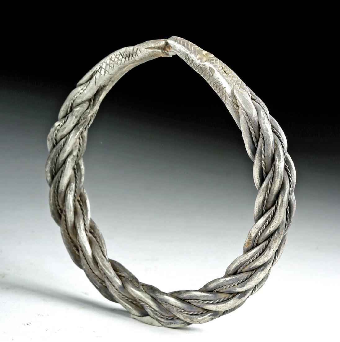 Huge Viking Silver Bracelet w/ Snake Terminals - 91.7 g: Northern Europe, Viking culture, ca. 8th to 10th century CE. A large, heavy solid silver bracelet (97% silver) with serpent-headed terminals. The center of the bracelet is in the form of braided thick