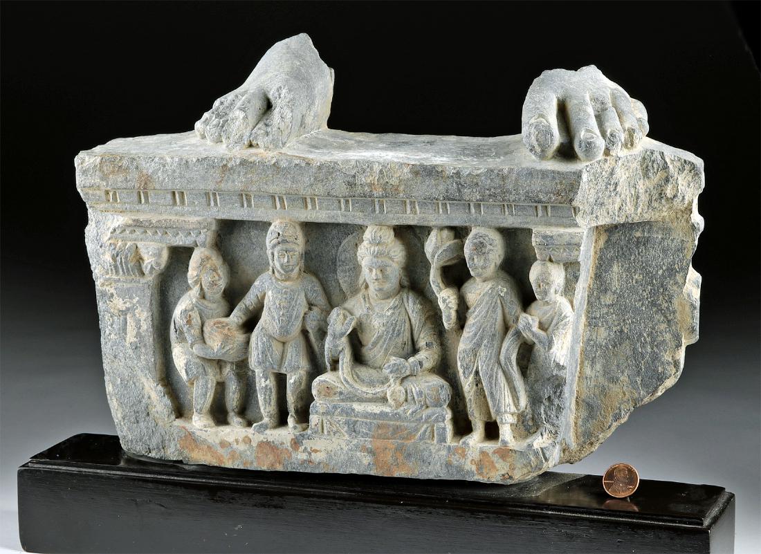 Gandharan Stone Relief w/ Buddha, Attendants, & Feet: Central Asia, Pakistan and Afghanistan, Gandharan Empire, ca. 200 BCE to 200 CE. A sparkling grey schist panel carved in high relief with a scene of seated Buddha and four attendants posed around him,