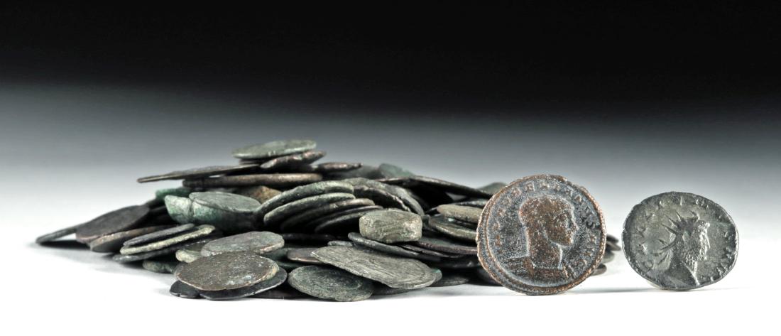 Lot of 140 Assorted Roman Bronze Coins, 341.9 g: Roman, Imperial Period, ca. 1st to 4th century CE. A fine ensemble of 140 circular die-stamped bronze coins from the Roman Empire. Many coins feature portraits of various emperors surrounded by Latin