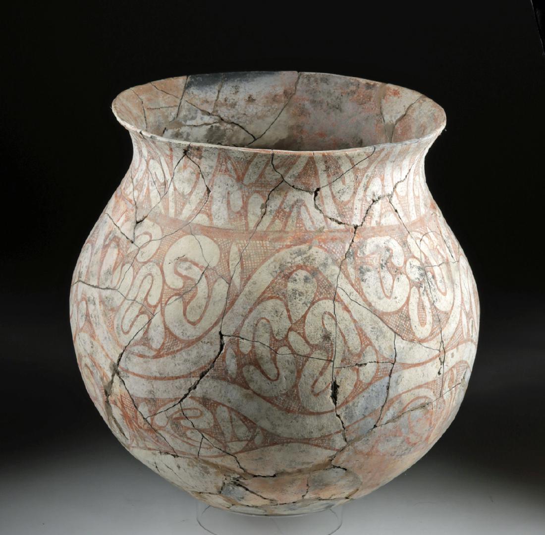 Huge Ban Chiang Pottery Vessel: Ancient Southeast Asia, Thailand, Ban Chiang, ca. 300 BCE. A massive and beautiful bi-chrome pottery vessel with a rounded base, a globular body with a rounded shoulder, a deep interior cavity, and a 