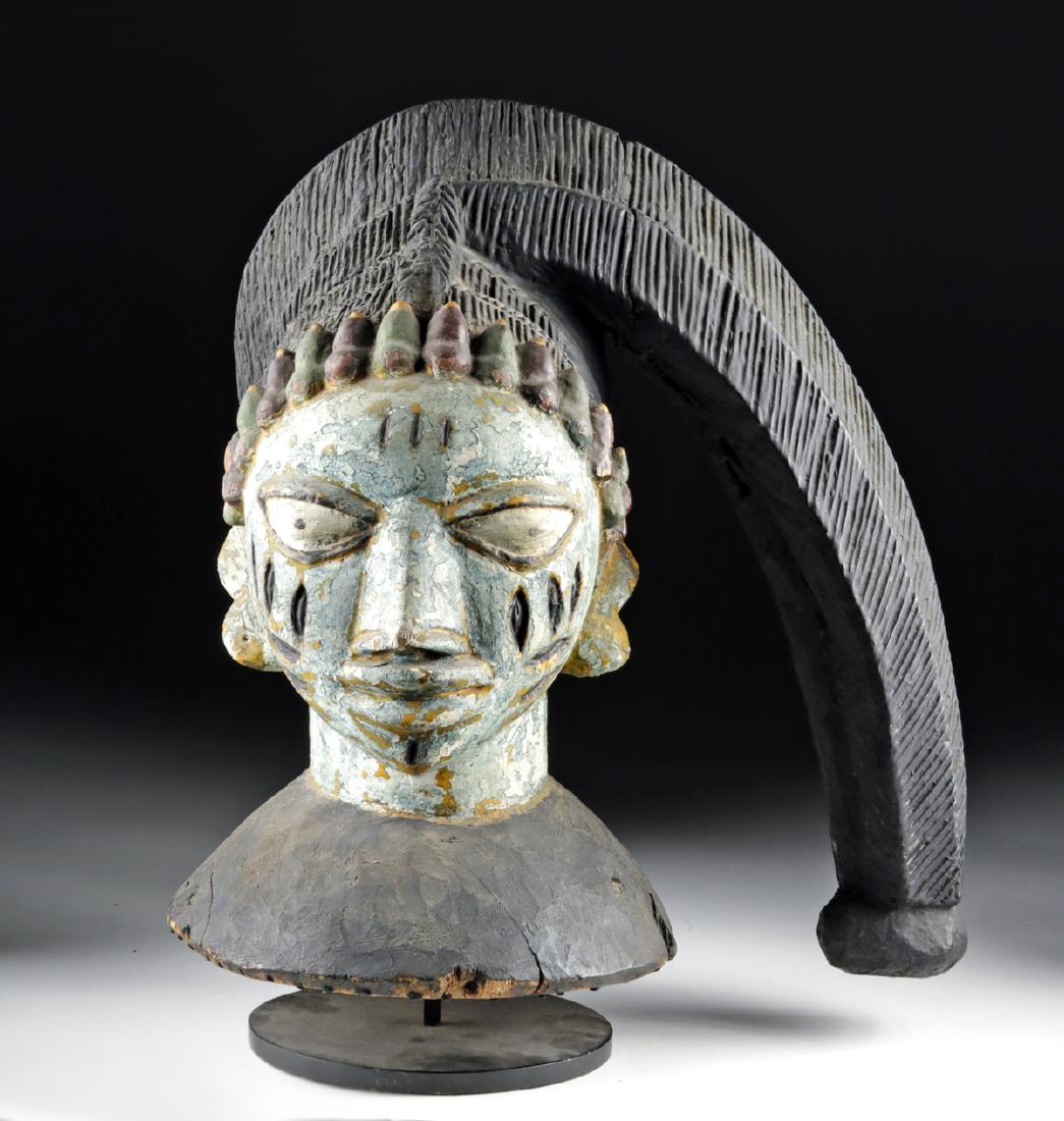 Mid-20th C. Yoruba Wood Egungun Headpiece: West Africa, Nigeria, Yoruba peoples, ca. mid-20th century CE. A beautiful example of one of the most distinctive forms of West African masks, this helmet mask shows a gentle face topped with an elega