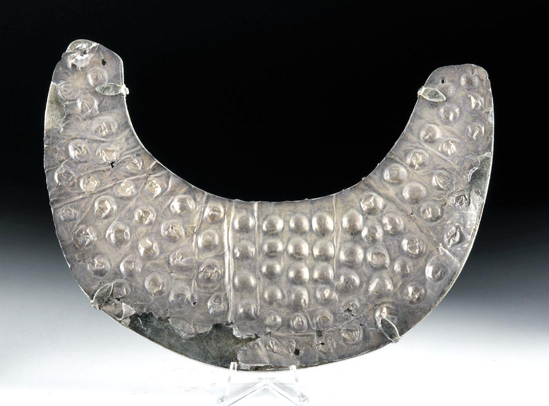 Sican / Lambayeque Silver Pectoral: Pre-Columbian, north coast of Peru, Sican / Lambayeque culture, ca. 750 to 1370 CE. A high-quality (97%) silver lunate pectoral, elaborately decorated with rows and rows of circular bosses in repousse