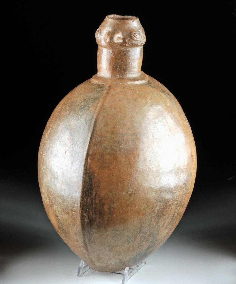 Narino Pottery Jar w/ Avian Head: Pre-Columbian, Colombia, Carchi-Narino Highlands, Narino culture, ca. 500 to 1000 CE. A mold-formed and highly-burnished pottery jar with a rounded base, an enormous body with well-defined lateral rid