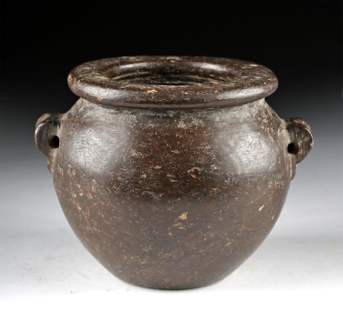 Egyptian Predynastic Granite Jar w/ Lug Handles: Ancient Egypt, Pre-Dynastic Period, Naqada II, ca. 3400 to 3200 BCE. A stunning jar of a squat size, hand-carved from mottled dark orange-brown granite with deep burgundy and black inclusions. The ves
