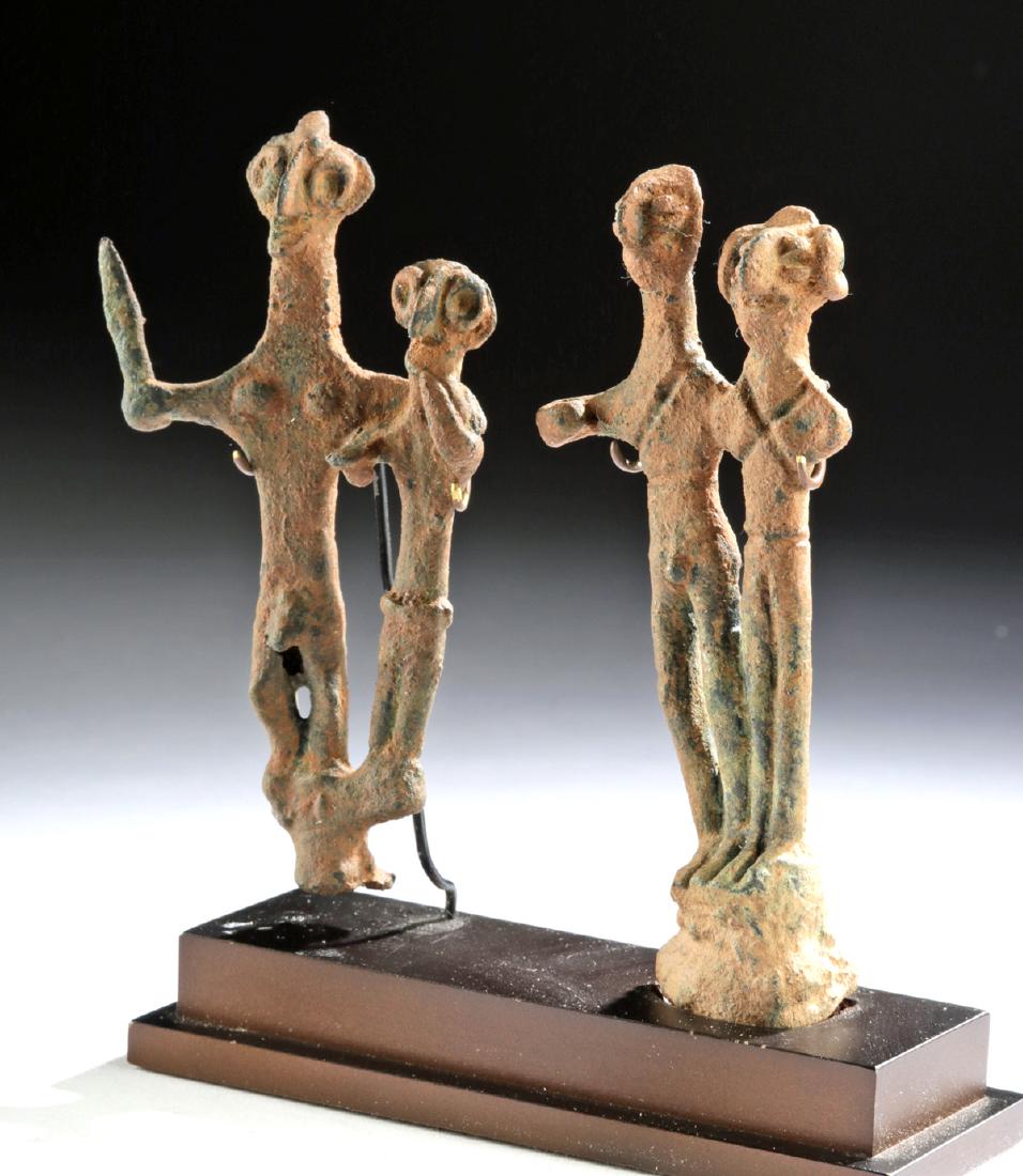 Anatolian Hittite Copper Standing Figures: Ancient Near East, Anatolia, Syro-Hittite, ca. 2nd millennium BCE. A fine gathering of two rare religious idol figures formed from copper. Each pair of figures stand atop an integral plinth, one bar-s