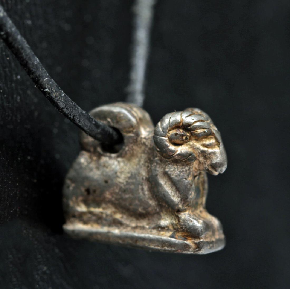Rare Egyptian Silver Amulet of a Ram - 3.9 grams: **Originally Listed At $200** Ancient Egypt, Late Period, ca. 664 to 332 BCE. A beautiful amulet, cast in silver, depicting a seated ram with a small loop on the back for suspension. The ram is symbol