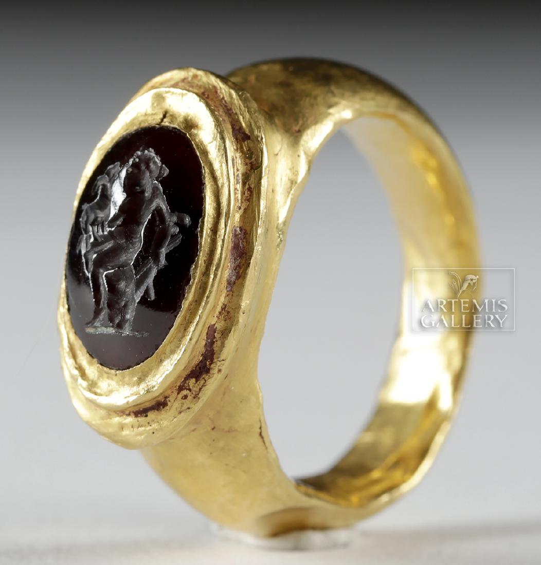 Roman 21K+ Gold Ring w/ Carnelian Intaglio - Satyr: Roman, Imperial Period, ca. 3rd to 4th century CE. A beautiful gold ring comprised of 88% gold (equivalent to 21K+ gold) with a thick band, gradually-expanding shoulders, and a raised bezel surrounded