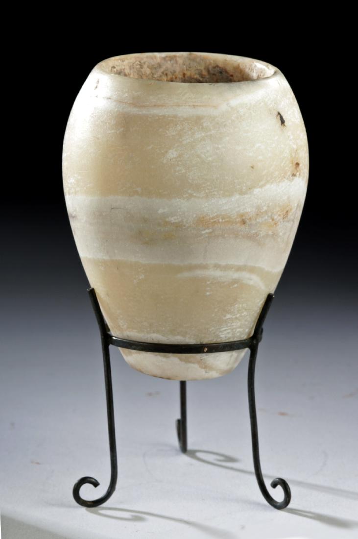 Egyptian Middle Kingdom Alabaster Jarlet: Ancient Egypt, Middle Kingdom, 18th to 20th Dynasty, ca. 1549 to 1076 BCE. A beautiful and finely-preserved jar of a petite form, hand-carved from creamy honey-yellow alabaster with milky-white veins 