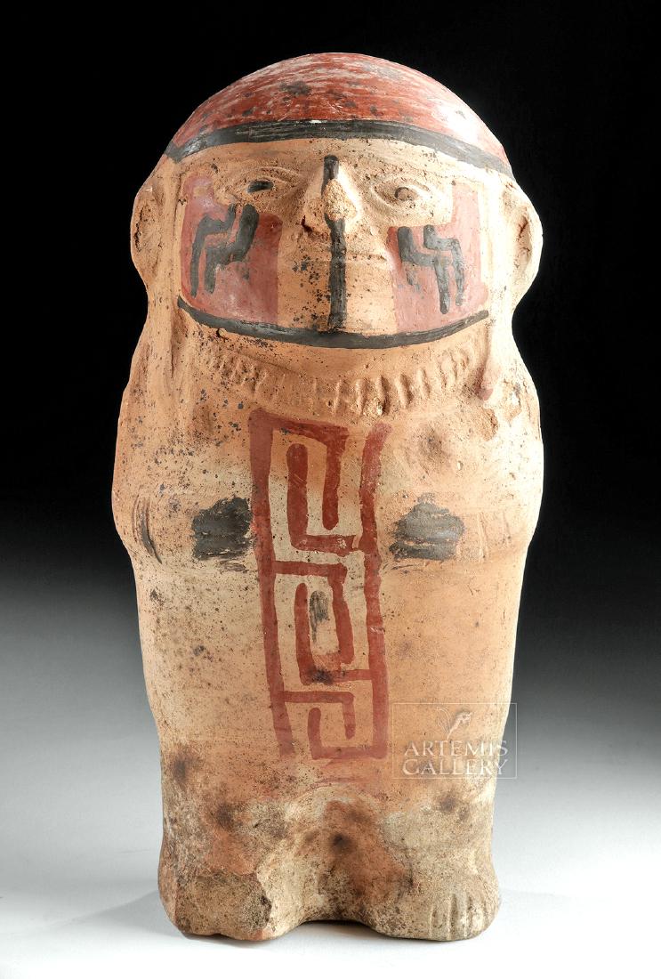 Huari Polychrome Female Effigy Rattle Figure: Pre-Columbian, south coast of Peru, Huari (Wari) culture, ca. 500 to 1000 CE. A charming mold-made ceramic effigy figure in the form of a standing woman. She has a thick body with relief hands that pr