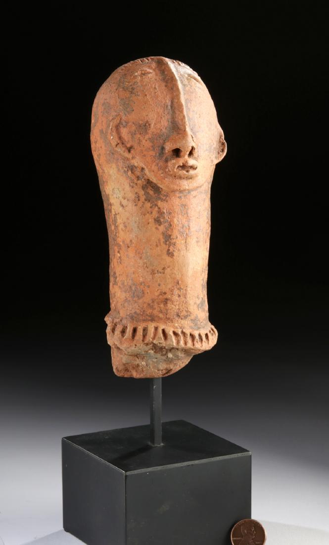 Bura Asinda Sikka Pottery Head: Africa, southwest Niger, Bura Asinda-Sikka, ca. 3rd to 13th century CE. A fascinating earthenware figure showing a human head with a rounded face, segmented brows, an extremely tall nose with flared n