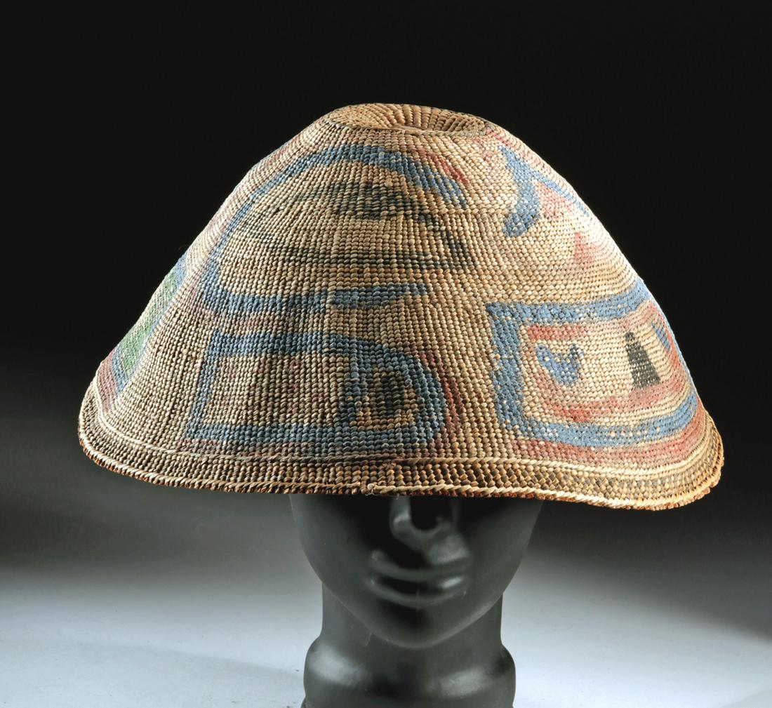 Early 20th C Nuu-chah-nulth Painted Woven Bark Rain Hat: Native American, Northwest Coast, Vancouver Island, Nuu-chah-nulth, ca. 1930s CE. An impressive rain hat comprised of woven cedar bark in a double weave with a boldly painted design in blue, green ora
