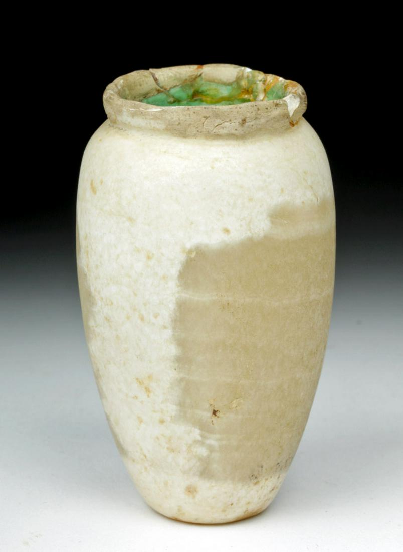Egyptian Middle Kingdom Alabaster Jar: Ancient Egypt, Middle Kingdom, ca. 2040 to 1802 BCE. A charming alabaster jar with a rounded body that widens as it rises. A wide, round mouth with a slight rim reveals the drilled interior. Alabaster