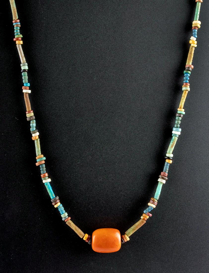 Egyptian Faience Bead Necklace w/ Carnelian Pendant: Ancient Egypt, Third Intermediate to Late Dynastic Period, ca. 1070 to 332 BCE. A beautiful and wearable necklace composed of hundreds of glazed faience beads in seed and tubular forms. Slender tube-f