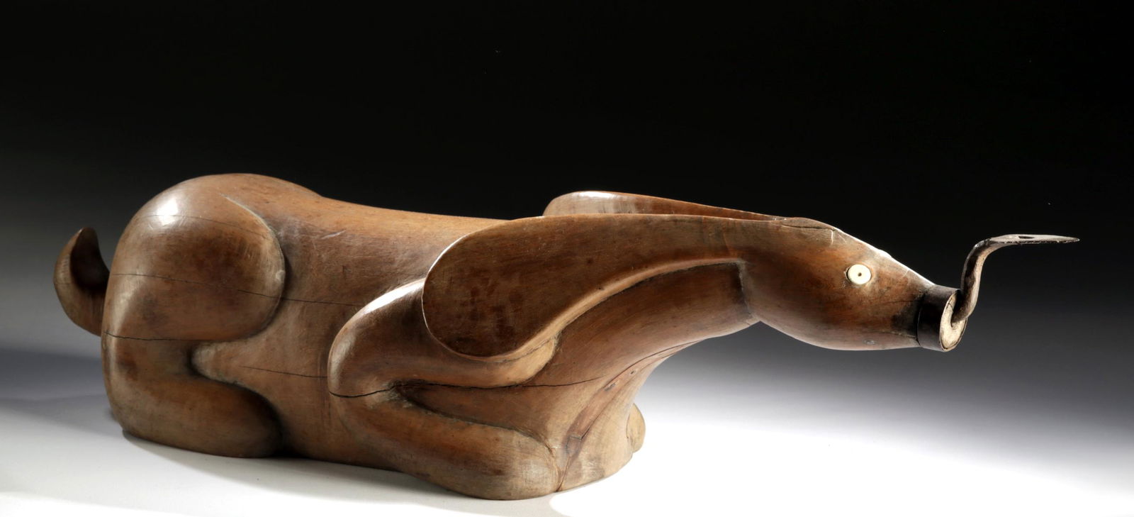 Adorable 19th C. Thai Wood Rabbit Coconut Grater: Southeast Asia, Thailand or Cambodia, ca. late 19th to early 20th century CE. A hand-carved wooden coconut grater hand-carved in the form of a recumbent rabbit. The bunny rests atop a quartet of retra