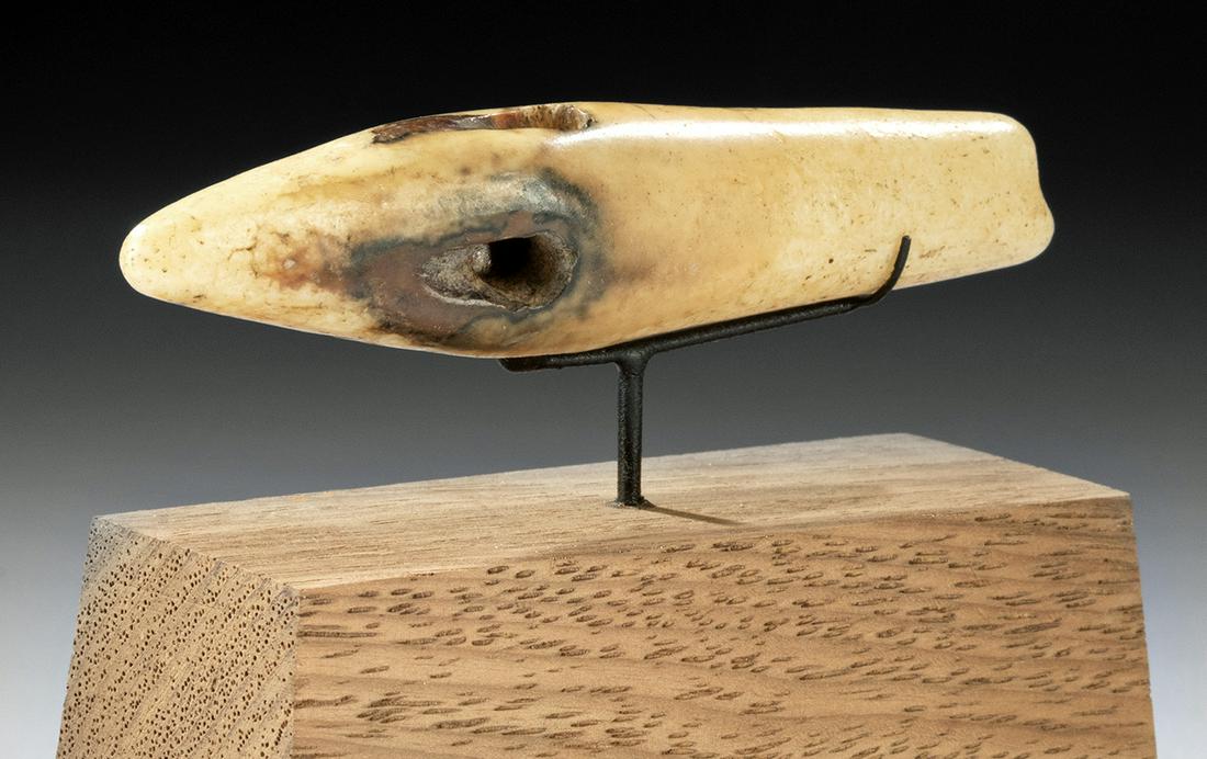19th C. Alaskan Yupik Cod Fishing Lure: Native American, found on St. Lawrence Island, Alaska, Yupik people, ca. 19th century CE. A gorgeous caribou bone fishing lure, carved in the shape of a fish with a diminutive tail and a pointed nose.