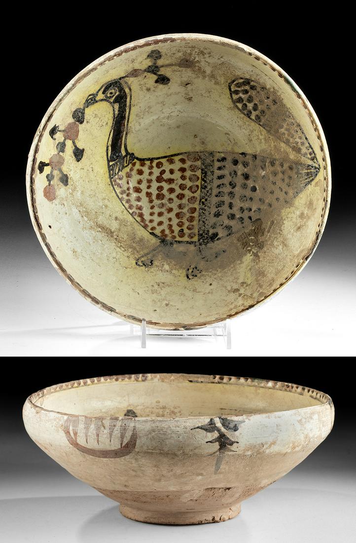 Islamic Nishapur Polychrome Bow wl / Bird, TL Tested: Ancient Near East, Iran, Nishapur, ca. 10th century CE. A beautiful glazed earthenware bowl of a wheel-thrown rounded form on a short foot and handsomely decorated with a large bird holding a berried 