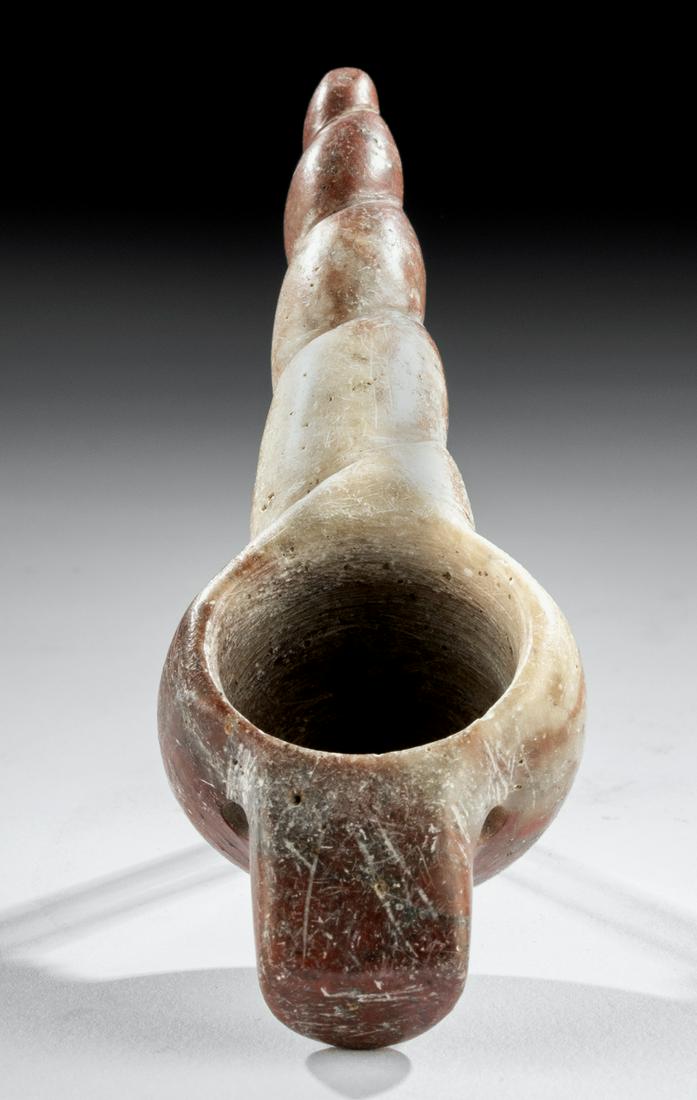 Tairona Jasper Drug Spoon w/ Spiral Pattern: Pre-Columbian, Colombia, Tairona, ca. 1000 to 1500 CE. A lovely hand-held drug implement carved from a mottled red stone with white inclusions known as brecciated jasper. The spoon has a large recepta