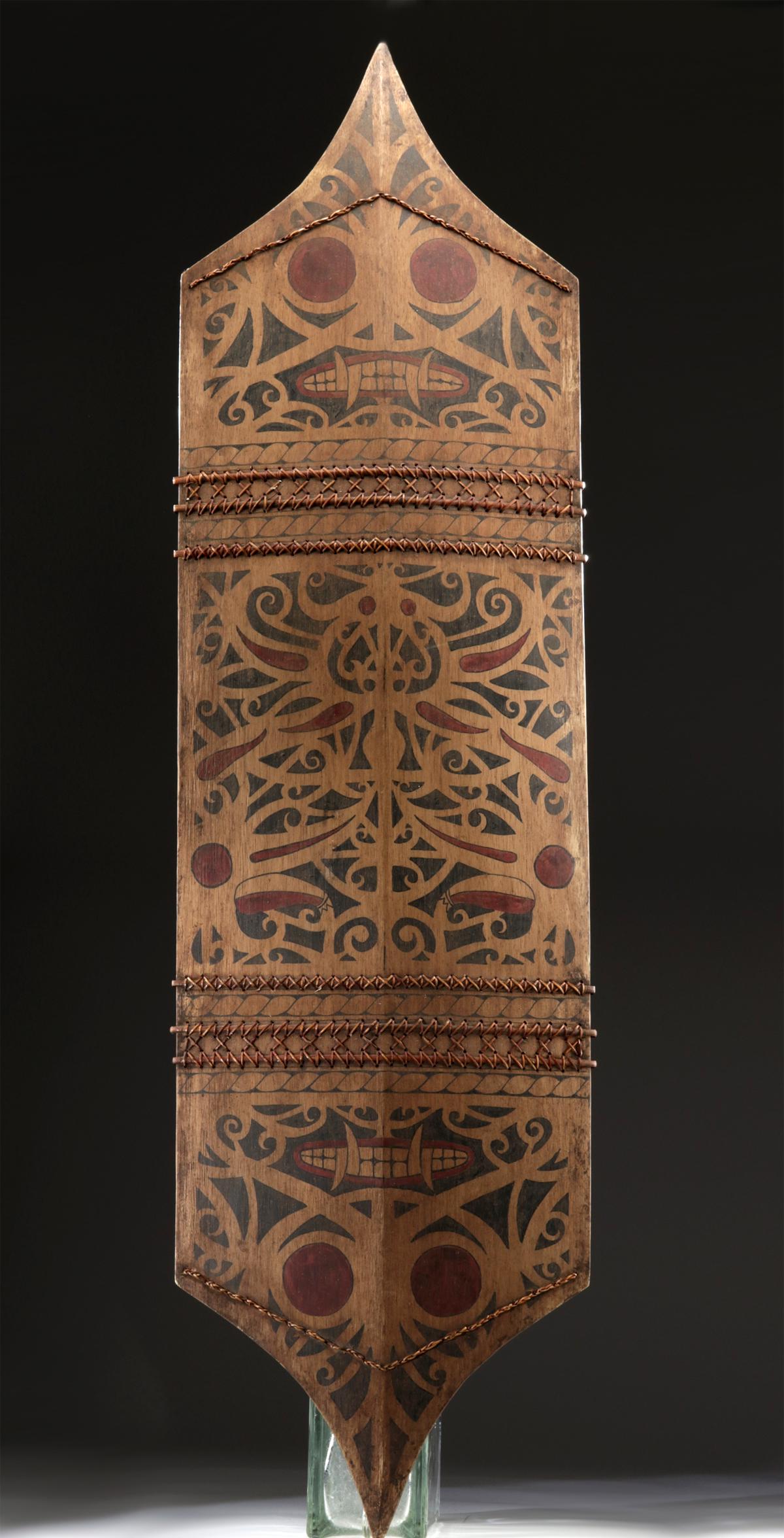 19th C. Dayak Mualang Painted Wood War Shield: Southeast Asia, Indonesia, Central Kalimantan, Dayak Mualang peoples, ca. late 19th to early 20th century CE. A beautiful war shield carved from a single plank of lightweight wood. The diamond-shaped 