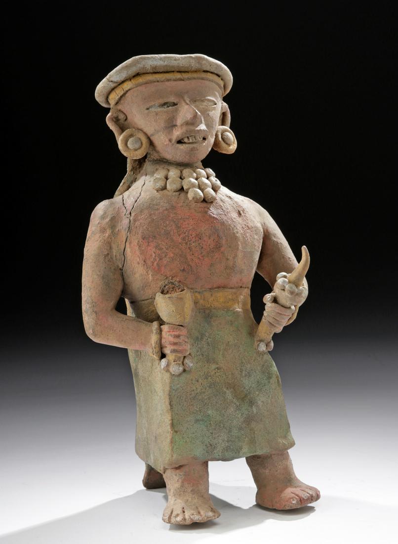 Rare Teotihuacan Polychrome Standing Figure: Pre-Columbian, Valley of Mexico, Teotihuacan, ca. 150 to 650 CE. A stunning ceramic portrait of an enigmatic person holding ceremonial implements, composed of intricately molded ceramic forms carefull