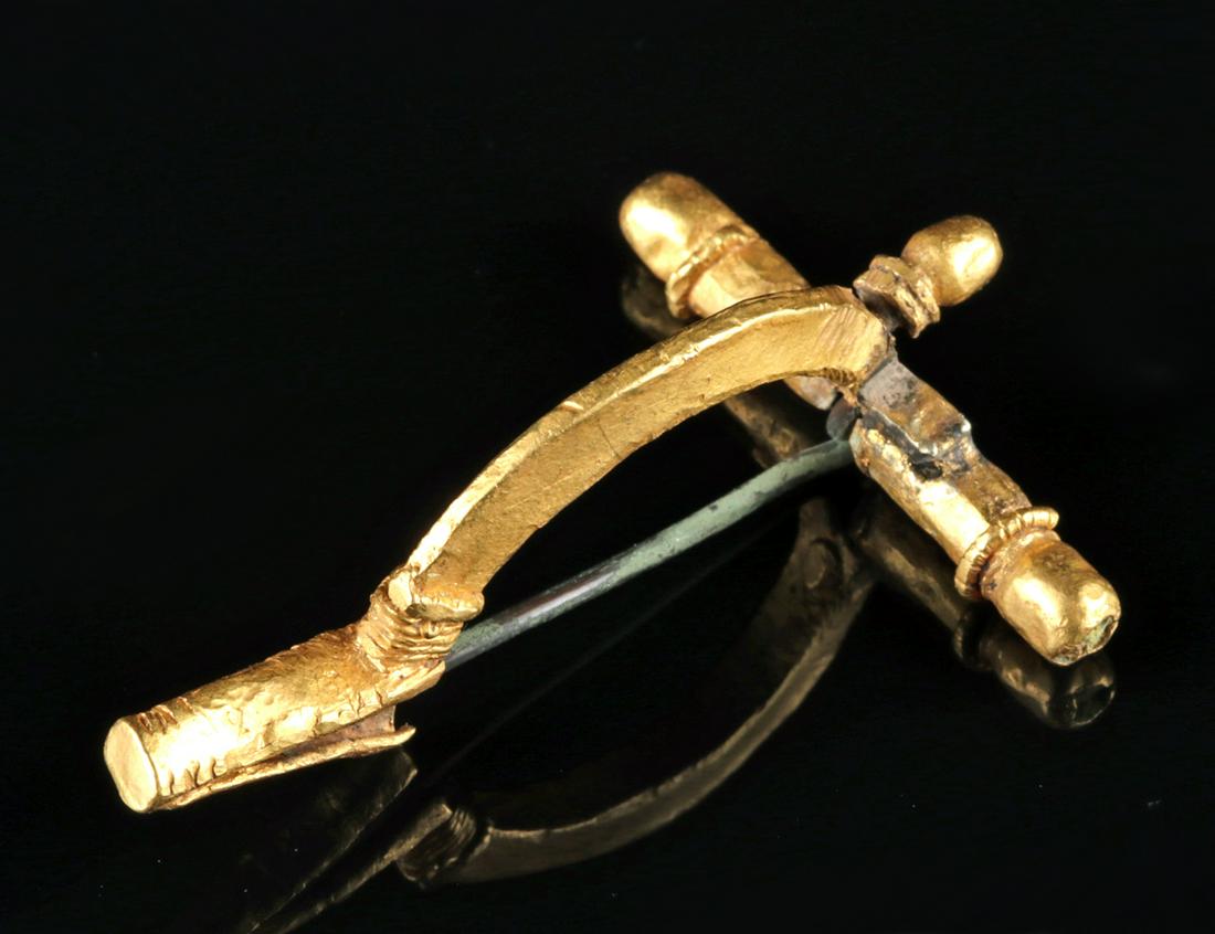 Published / Large Roman Gold Crossbow Fibula: Roman, Imperial Period, ca. 4th century CE. A beautiful, large, gold "crossbow" fibula or brooch with a bronze pin used to fasten a cloak of a Roman soldier and citizen. It is cruciform, with slender 