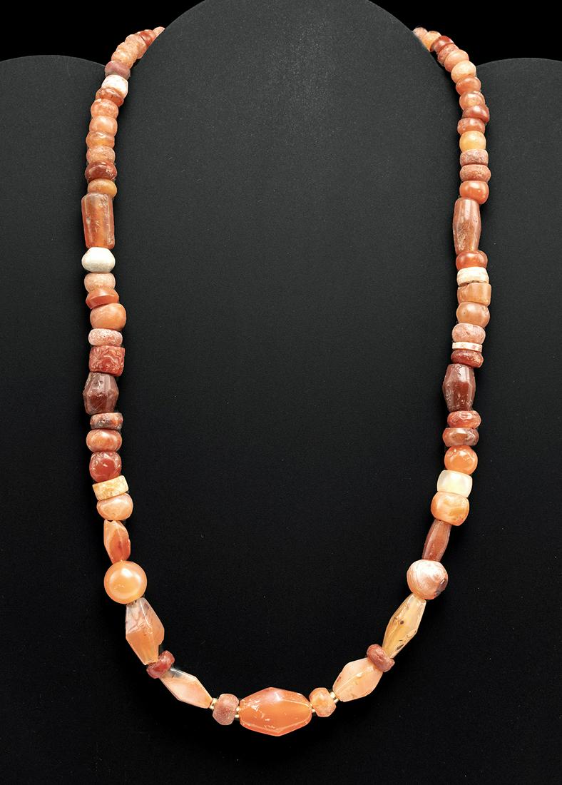 Viking Carnelian Bead Necklace - Lovely & Wearable: Northern Europe, Viking or Norse culture, ca. 8th to 11th century CE. A gorgeous necklace strung with dozens of tubular, discoid, spherical, and carinated beads carved from carnelian of warm orange an