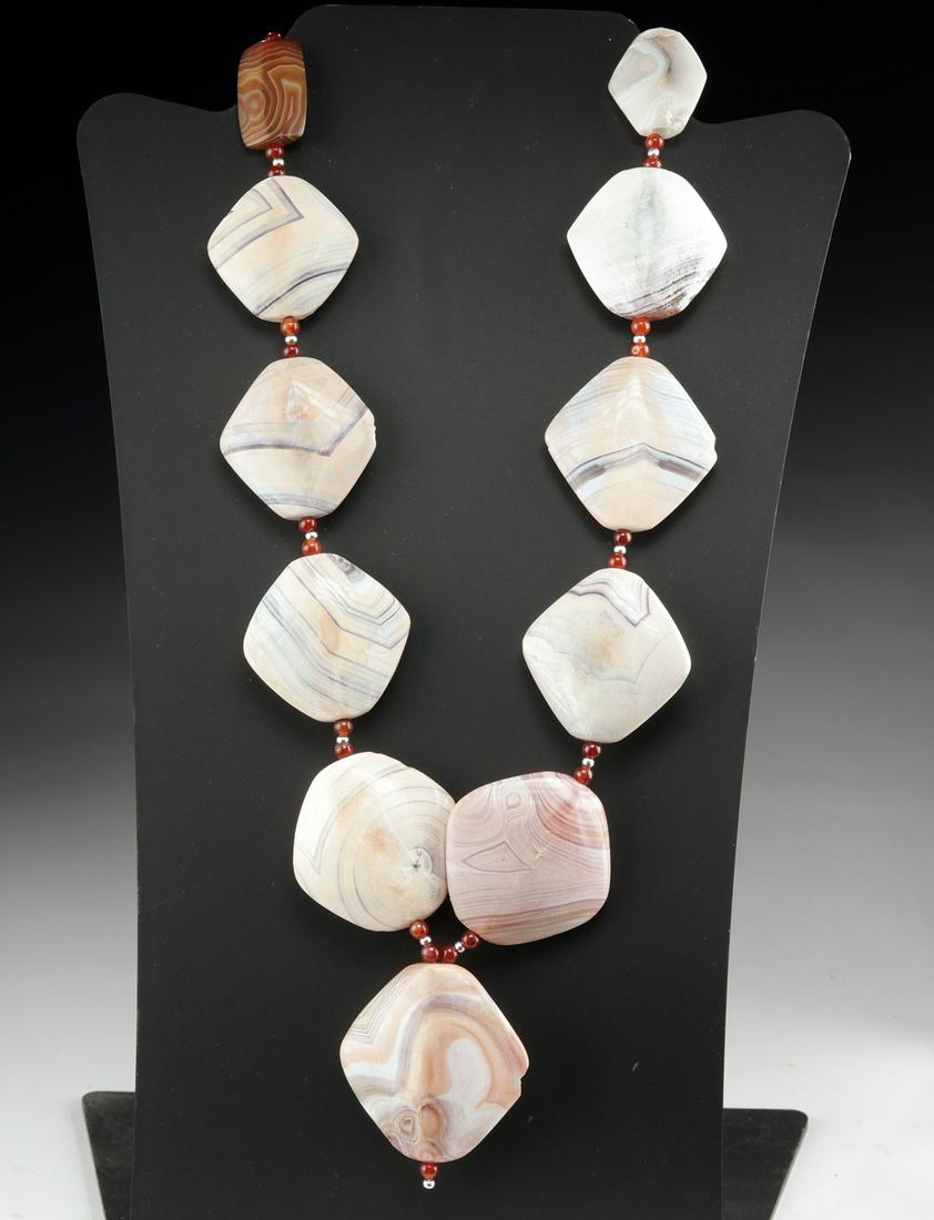 Bactrian Banded Agate Necklace w/ Carnelian Beads: Ancient Central/Western Asia, Bactrian Empire, ca. 1st millennium BCE. A gorgeous necklace composed of eleven broad beads carved from stunning banded agate. Each of the agate beads presents with natur