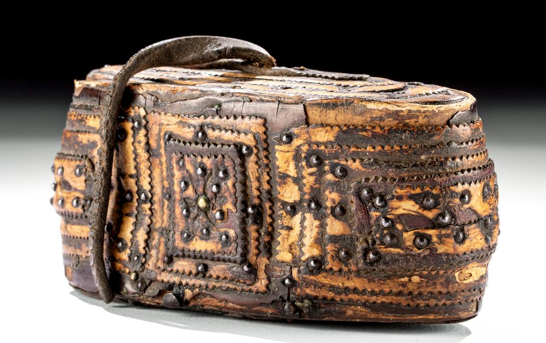 Mid-19th C. American Birch Bark & Leather Tobacco Box: North America, Great Lakes region, ca. mid-19th century CE. A hand-built wooden tobacco box lined with birch bark as well as dozens of decorative iron studs. The ovoid container has a removable, form-