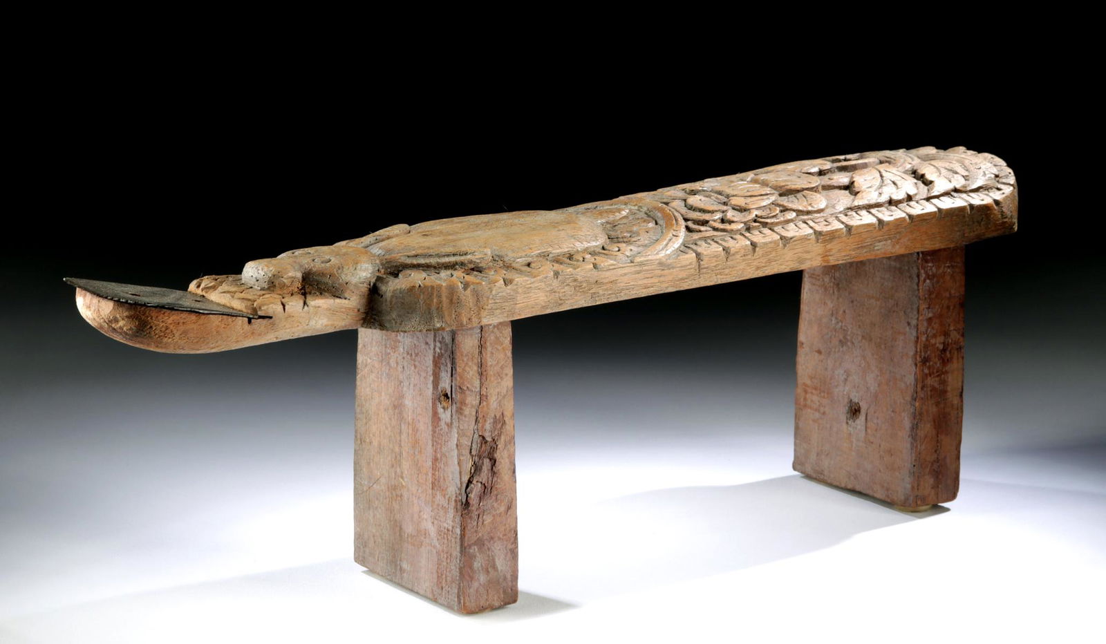 19th C. Asian Coconut Grater - Rabbit w/ Flowers: Southeast Asia, Thailand or Cambodia, ca. late 19th to early 20th century CE. Intricately carved, a wooden coconut grater presenting a prone rabbit with laid back ears, round eyes, a pleasantly plump