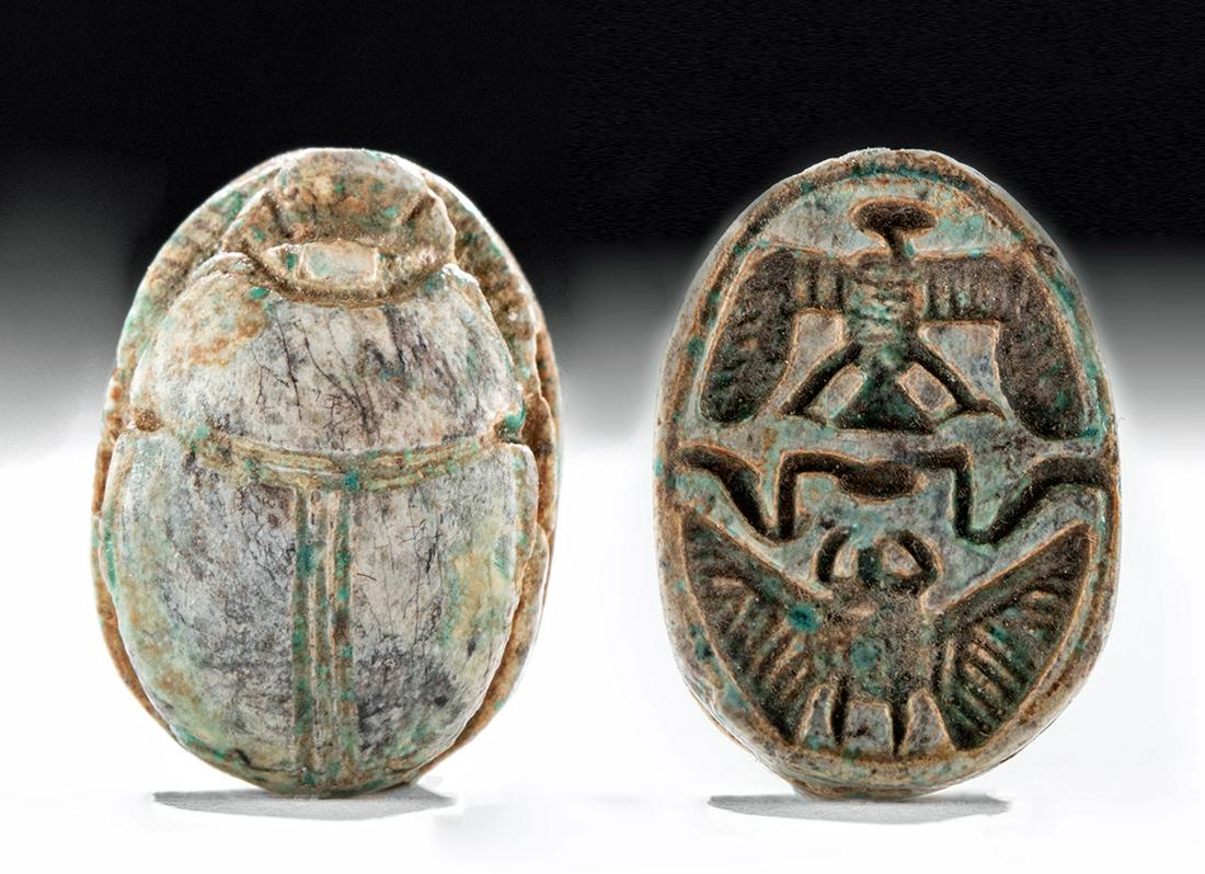 Egyptian Glazed Faience Scarab Amulet - ex Mitry: **First Time At Auction** Ancient Egypt, New Kingdom, 19th Dynasty, ca. 1292 to 1189 BCE. A mold-formed faience amulet in the form of a scarab beetle. The insectile features along the top include a fo