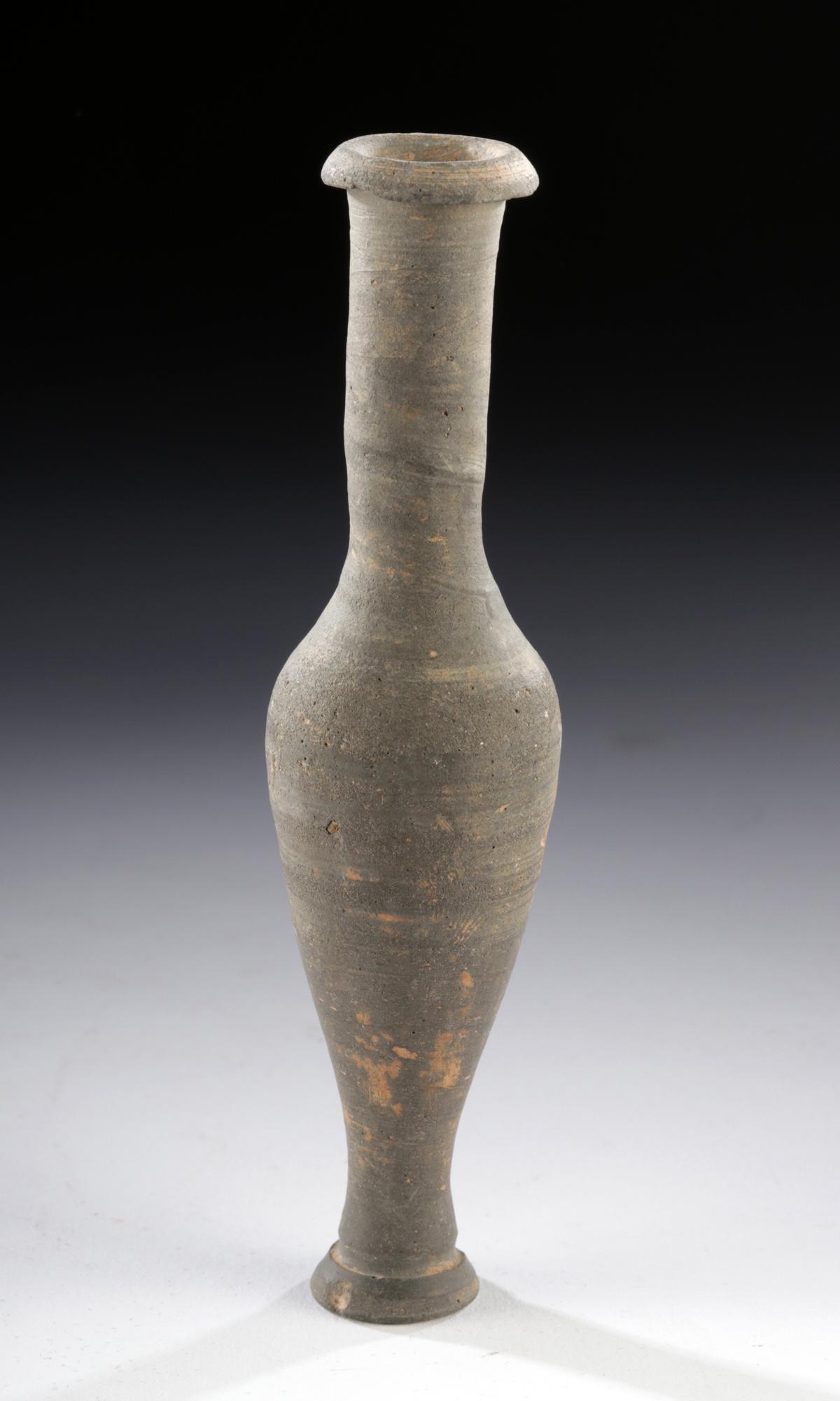 Greek Hellenistic Terracotta Spindle Flask: **First Time At Auction** Greece, Hellenistic Period, ca. 3rd to 1st century BCE. A lovely wheel-thrown pottery vessel of a slender form known as a "spindle flask" with a petite foot, an inverted piri